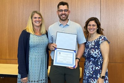 Recent DPT graduate Justin Cormier receives the clinical excellence award for solving a complex case of a patient suffering with a concussion. He is shown with Associate Teaching Professor Michele Fox and Clinical Education Coordinator Becky Glass.