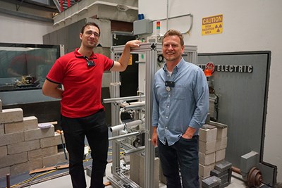 Physics Ph.D. student Razvan Stanescu and Assistant Professor Marian Jandel pose alongside the Mixed Array of Detectors. When in use, neutrons beam through the setup and induce nuclear reactions studied by this array.