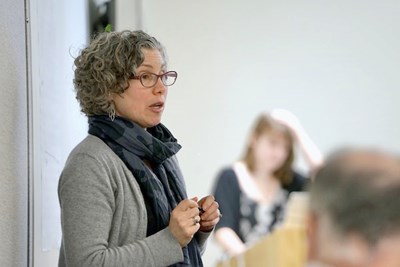 UMass Lowell professor Juliette Rooney-Varga giving a lecture in a classroom