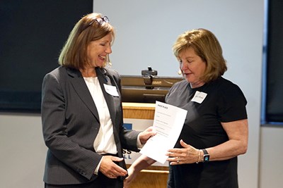 Associate Vice Chancellor for Industry Partnerships and Economic Development Arlene Parquette, left, presents ARTritech Digital Health's Nancy Briefs with the Sensor Challenge's first-place prize.