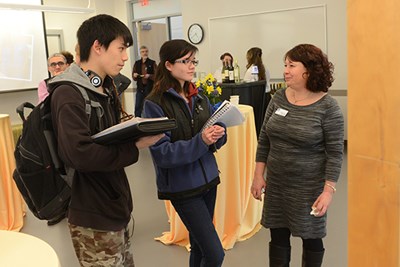 Assoc. Prof. of Nursing Ainat Koren speaking with two students in class