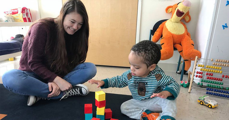 UMass Boston student plays memory games with a child