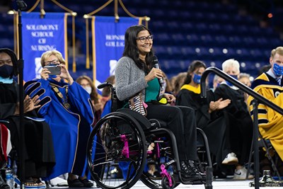 Computer engineering alumna Sanskriti Sharma '20, whose 'Wonderwheel' team won DifferencMakers' First to Market Challenge last year, addresses students while Chancellor Jacquie Moloney snaps a photo.