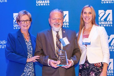 Vice Provost for Graduate and Professional Studies Steven Tello is presented with a gift from Chancellor Jacquie Moloney, left, and DifferenceMaker Director Holly Lalos during the anniversary celebration.