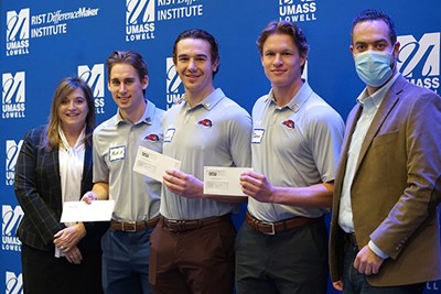 The StockToMe team of, second from left, Matt Allen, Matthew Kinash and Jackson Sterrett, hold their winning Innovation Contest checks with Manning School of Business Dean Sandra Richtermeyer and DCU Innovation Manager Thomaz De Moura.