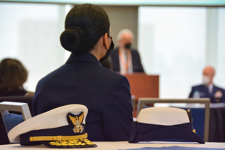 A Coast Guard Academy cadet looks on during the ceremony.