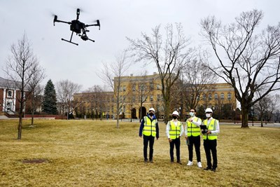 Mechanical Engineering Asst. Prof. Alessandro Sabato, left, and his research team demonstrate the infrared drone on North Campus.