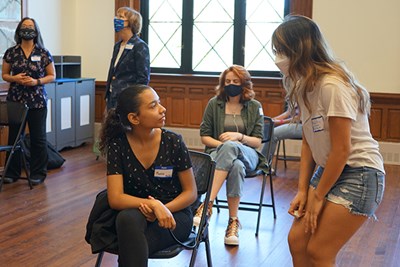 RHSA peer leader Monica Kong, right, checks in with a student during a break on a First to Launch Friday.