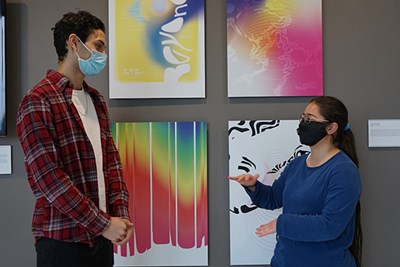 Honors students Ariel Shramko and Nilaish Sen talk to each other with masks on