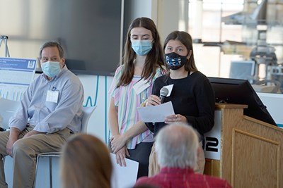 Biomedical Engineering Society co-presidents Devon Hartigan, right, and Irene Frechette welcome students to the internship networking event at M2D2.