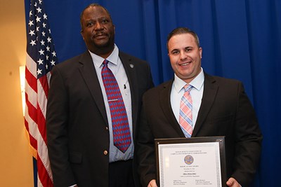 UMLPD Officer Brian Ethier, right, holds his Heroic Action Award alongside Chief Brashears.