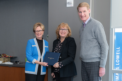 Chancellor Jacquie Moloney and Provost Joe Hartman present Katherine Tucker with the Distinguished University Professor award.