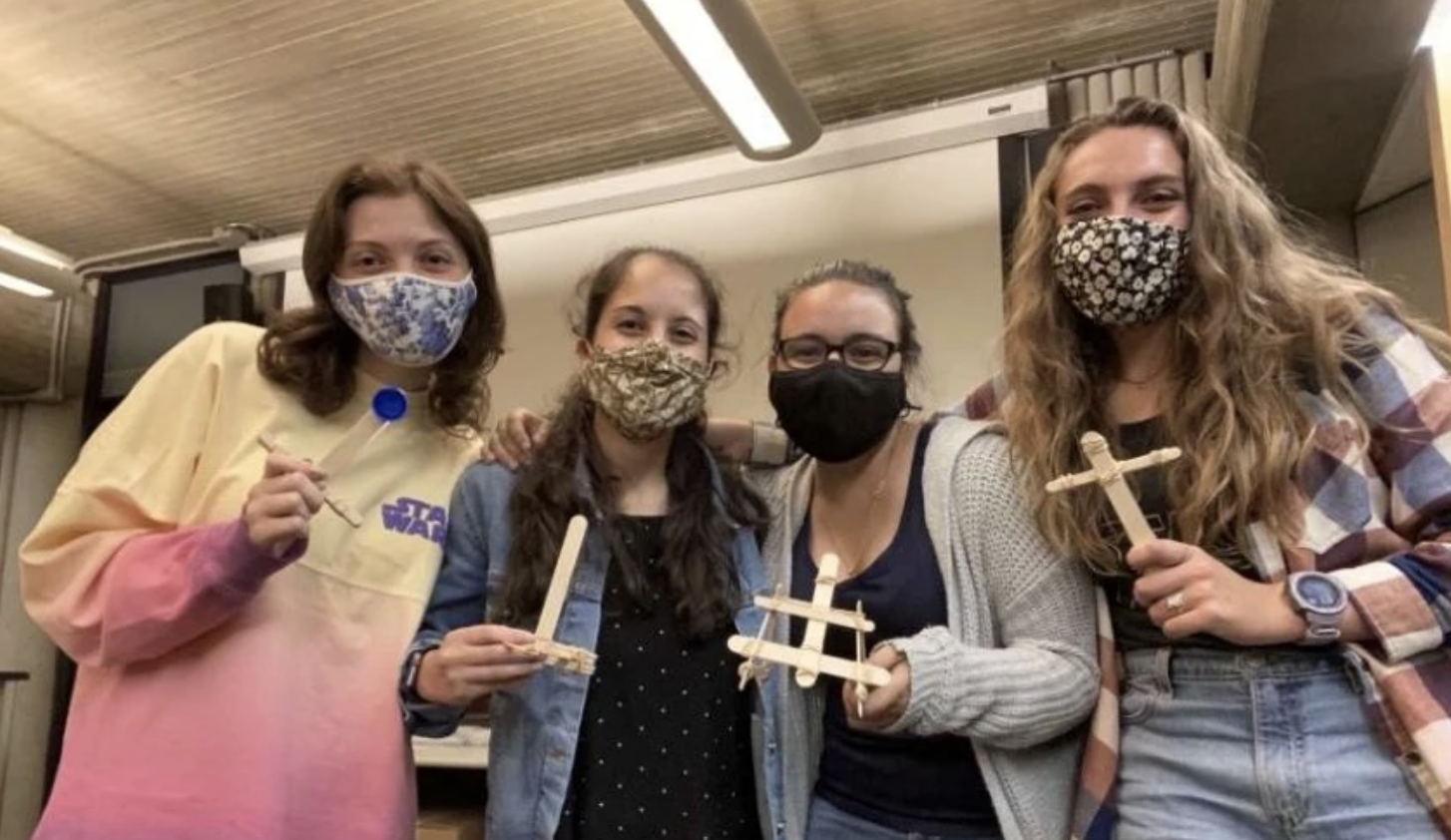 Society of Women Engineers e-board members practice building catapults in preparation for outreach at Acushnet Middle School. Pictured left to right: Jillian Wilson, Rebecca Rodrigues, Victoria Silva, Alexa Van Voorhis (Photo courtesy of A. Van Voorhis).