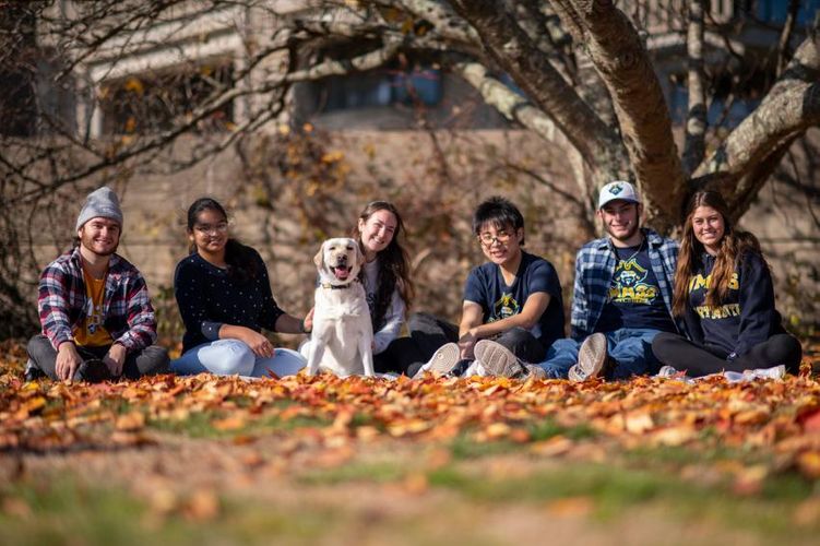 Gracie with students on the campus quad