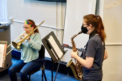 Margaret Wall, right, blows alto sax in a funk and fusion breakout session.