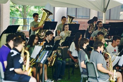 Symphonic Band Camp students play under a tent outside Durgin Hall on South Campus, where the camp returned this year after a one-year hiatus because of the pandemic.