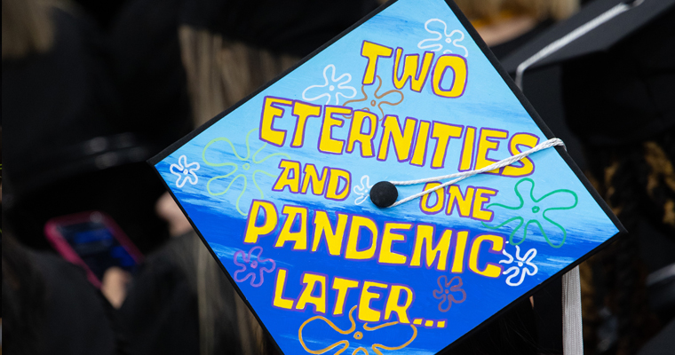 Graduate cap decorated with text: "Two eternities and one pandemic later..."