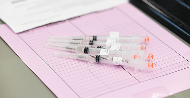 Image of medical syringes on a table