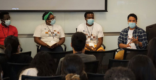 From left, GSN student Reginald Sarpong; MD/PhD candidate Abiola Ogunsola; Daniel Ugochukwu, SOM’24; and PhD candidate Cesar Bautista Sotelo speak during the Students of Color Orientation.