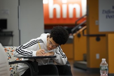 Anthony Marifiote of Lexington High School writes in his workbook during the College Exploration Seminar at Lydon Library.