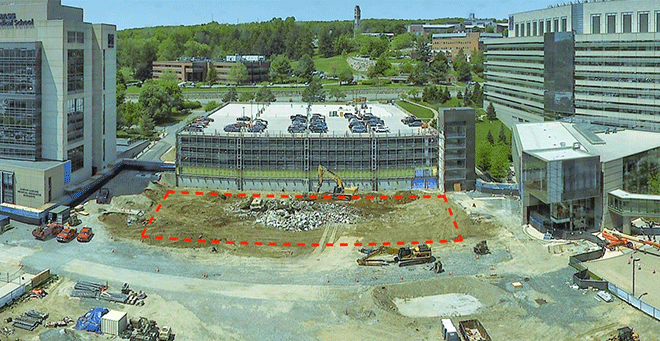 Crews are digging the foundation hole in the area outlined in red on the site photo