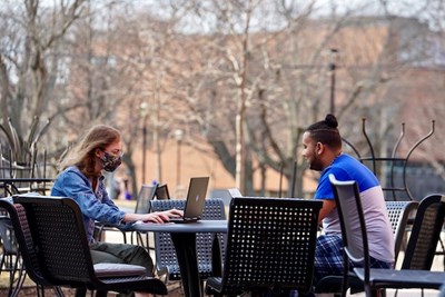 Students will be able to charge their devices with solar-powered umbrellas, which are being added to tables like this one across campus this summer.