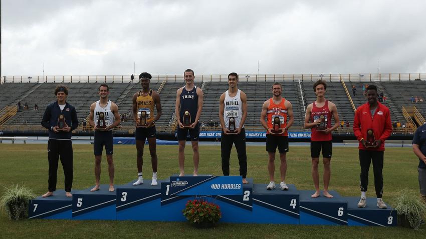 UMass Dartmouth sophomore Cameron Rodgers stands on podium along with fellow All-America honors recipients