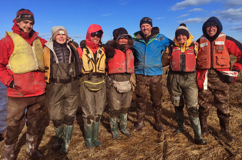 Baranes (second from right) and Woodruff (third from right) on the salt marsh with their team during spring break. Credit: UMass Amherst