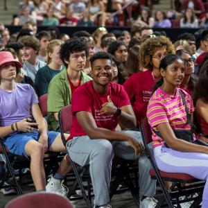 UMass Students in a crowd smile toward the camera