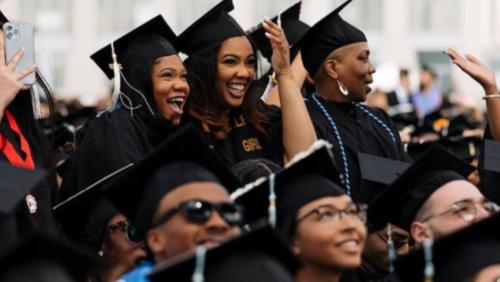 UMass Boston students cheering in the crowd at commencement.