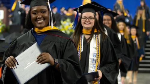 UMass Lowell students celebrating at commencement.